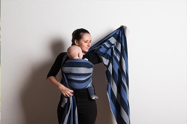 A mother making her own sling carrier.