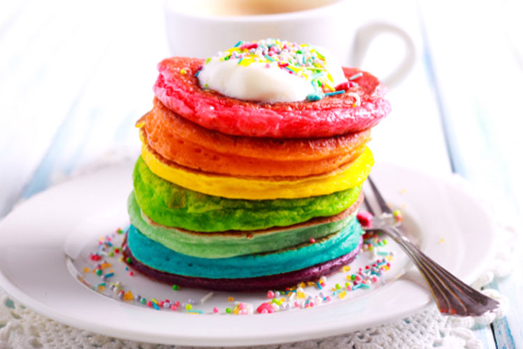 Colourful pancakes stacked on top of each other.