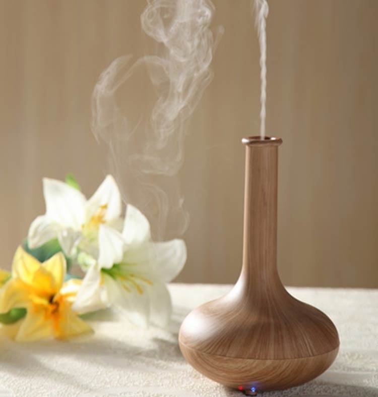 Picture of an aroma diffuser with flowers set up around it on a table