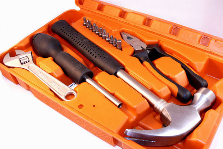 Picture of an orange toolbox with tools inside