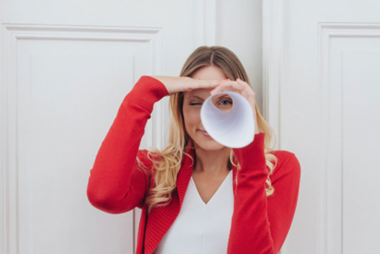 Woman looking through a paper cone!