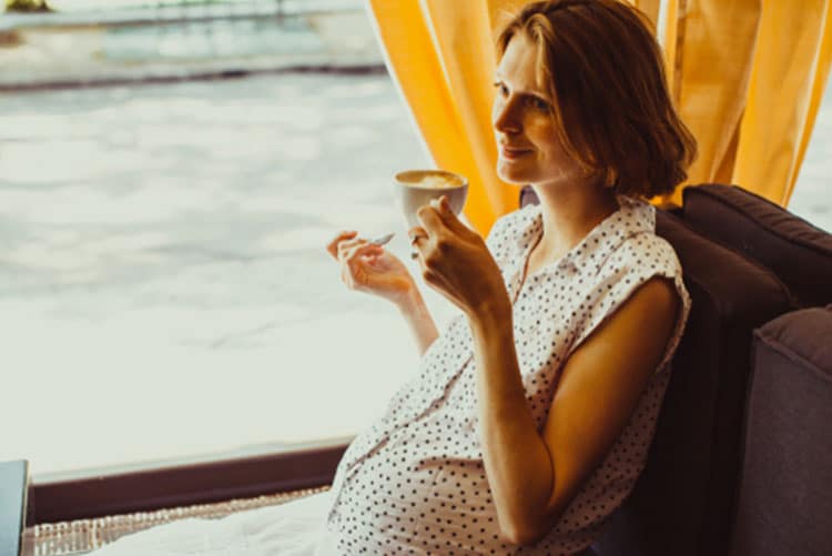 Pregnant woman drinking coffee